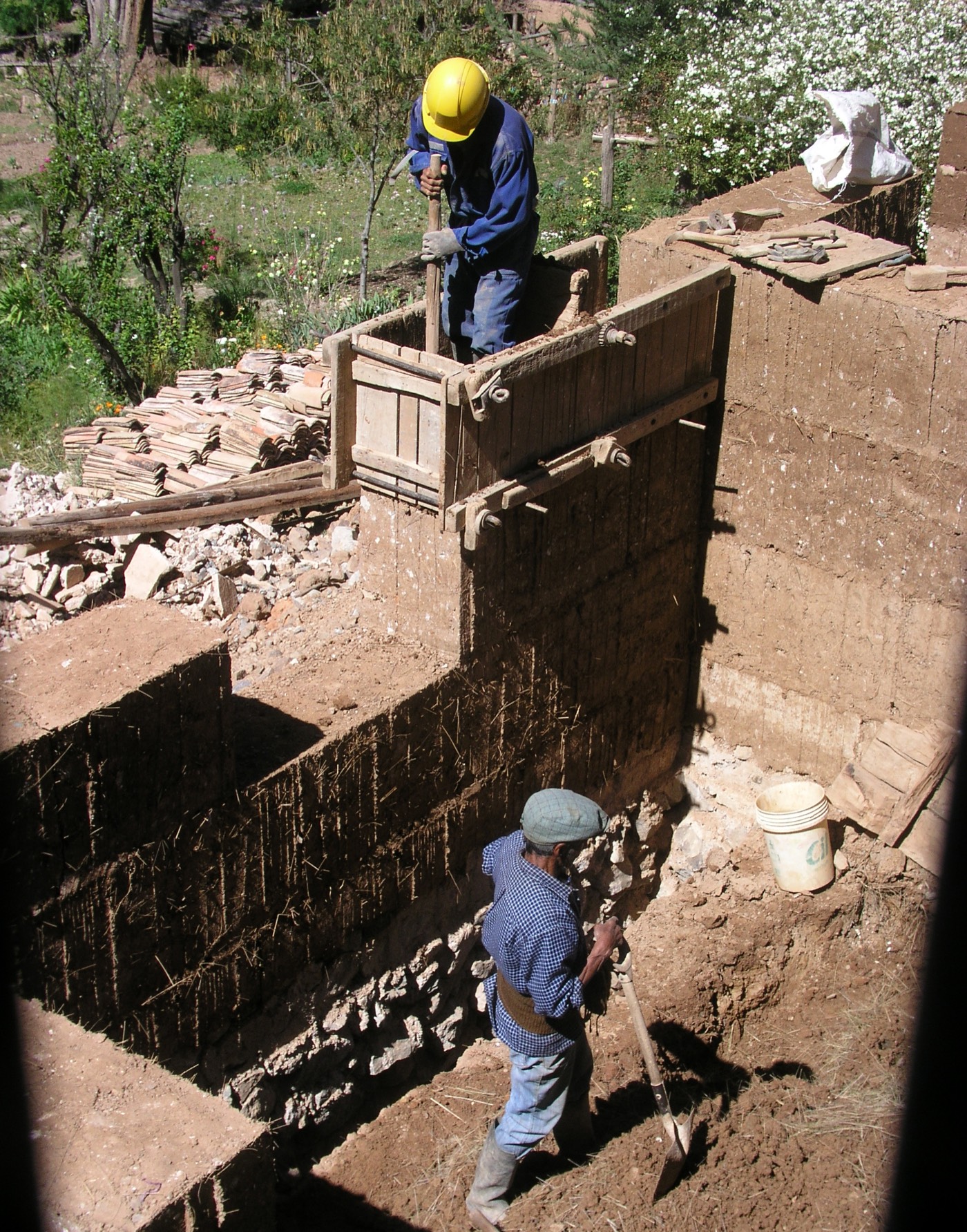 Stampflehm-Wandbau in einer Hacienda in Tarma, Peru — Einschichten und Verdichten von Erdmaterial in Holzschalung